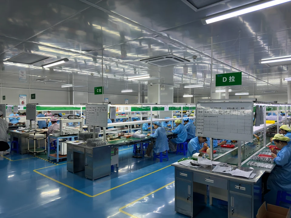 LH Tech hardware assembly lines with production staff, workstations and trays of components