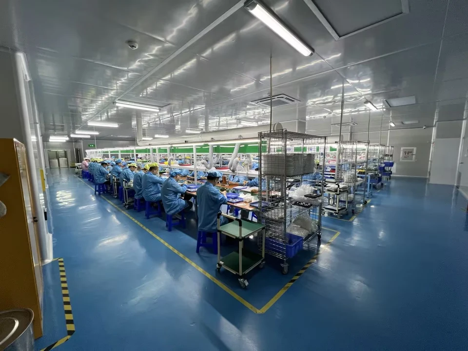 LH Tech factory production floor in China with staff working at organized assembly benches